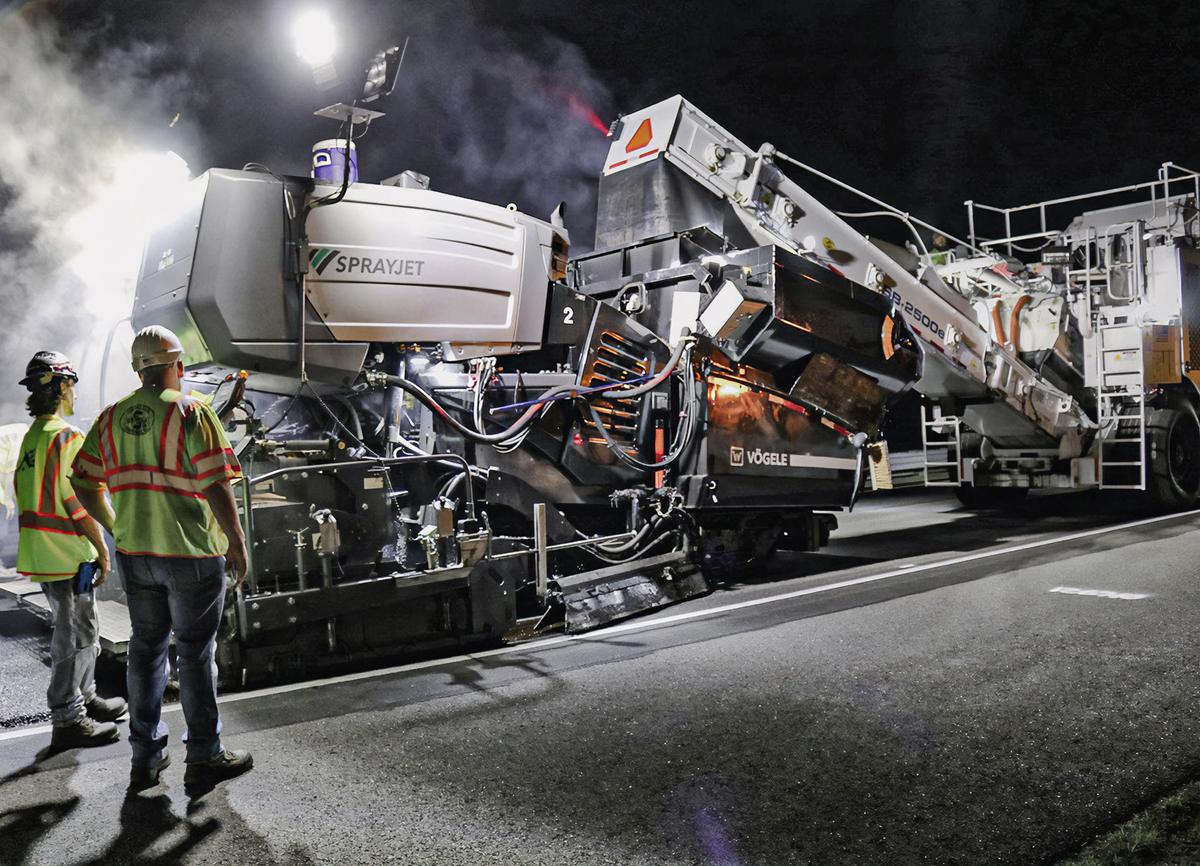 Extendedora Vögele SprayJet trabajando de noche